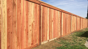 Redwood fence with cap and trim built by Alpha Fence Company