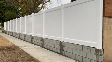 Vinyl fence on top of a block wall built by Alpha Fence Company